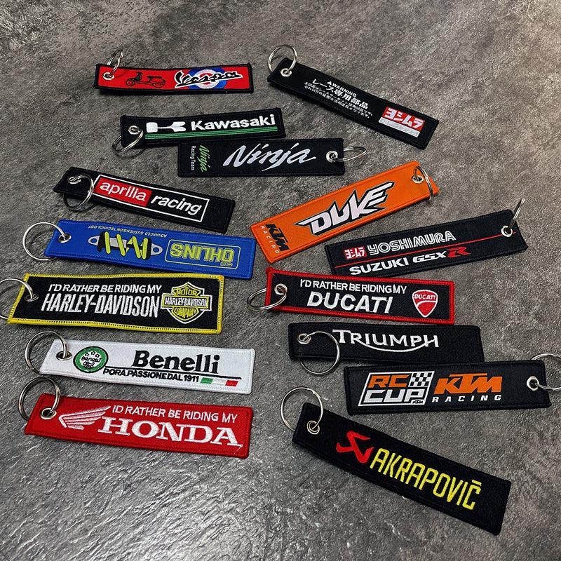 Embroidered motorcycle brand keychain decor featuring Bean's Moto Booth logo on a fabric keychain.