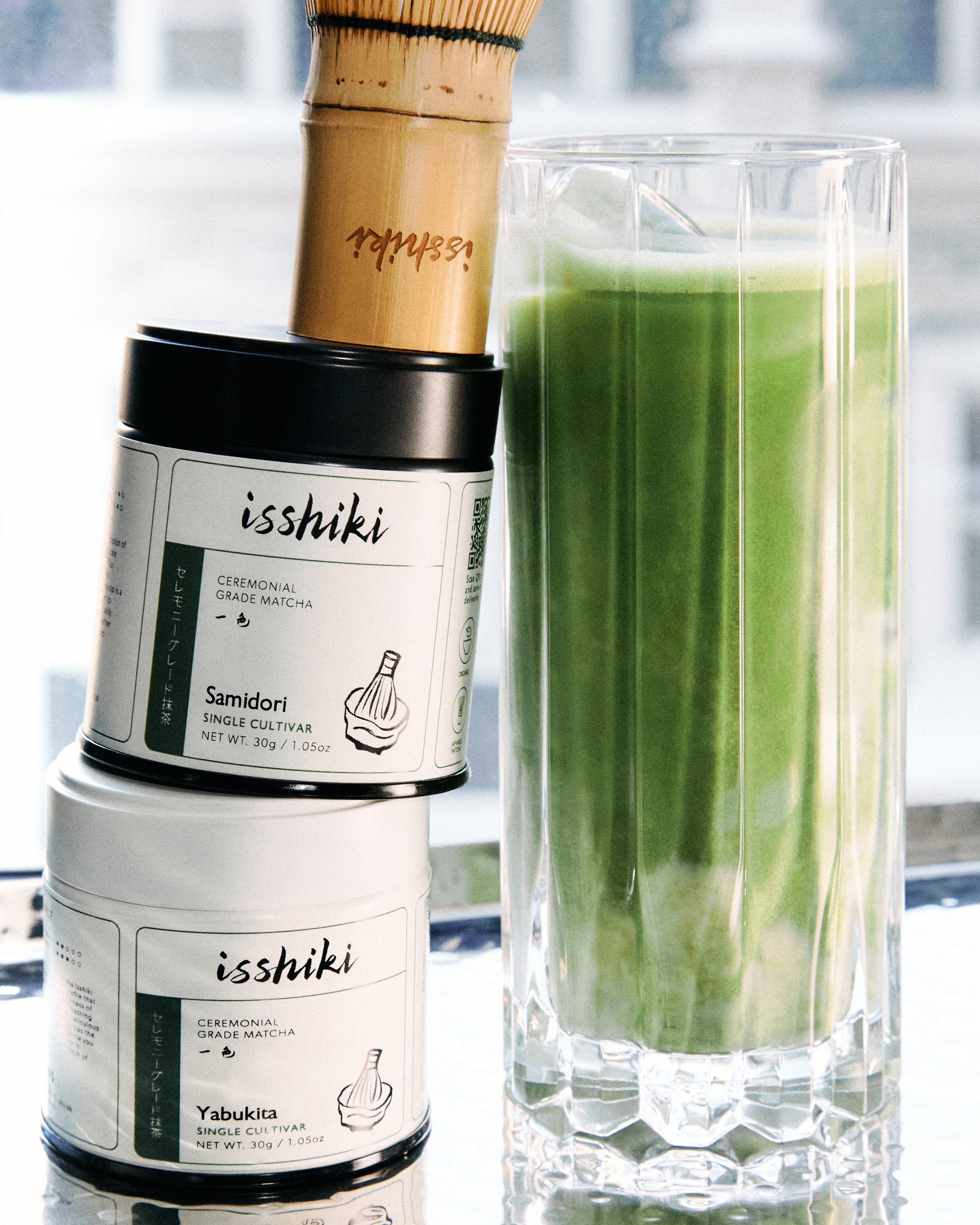 Fine green powder of isshiki matcha Samidori single cultivar premium matcha powder in a transparent jar.