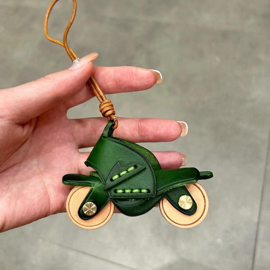 Handcrafted genuine leather motorcycle pendant decor with detailed motorcycle design, from Bean's Moto Booth.