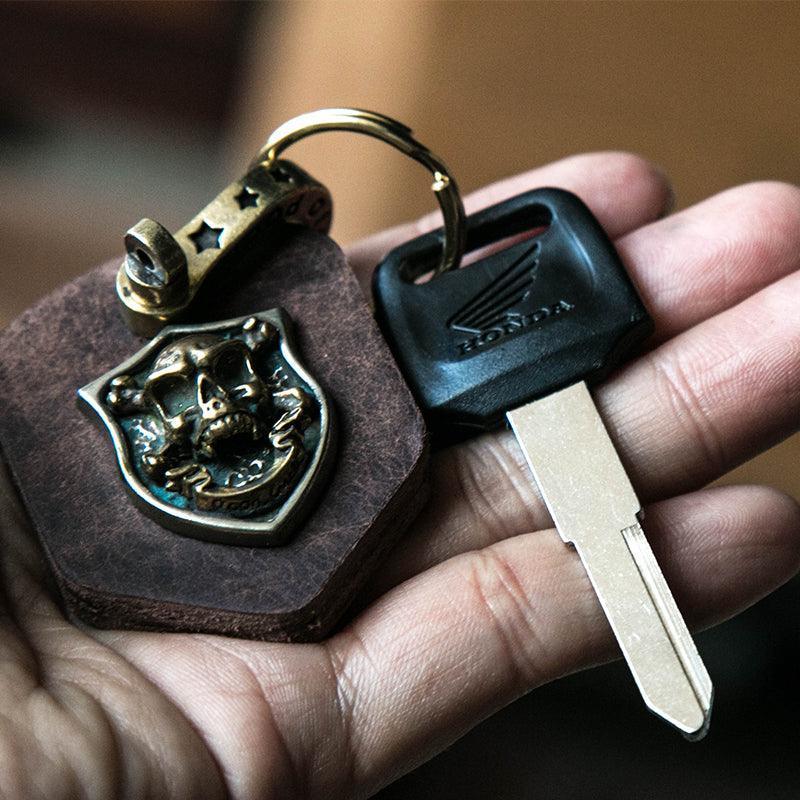 Handcrafted leather heavy metal motorcycle keychain decor with engraved details, featuring a rugged, stylish design from Bean's Moto Booth.
