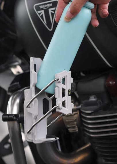 Bean's Moto Booth SMNU™ motorcycle adaptive anti-slip water bottle holder attached to motorcycle handlebar with secure grip.