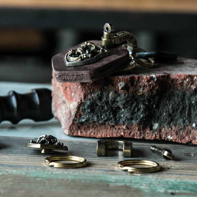 Handcrafted leather heavy metal motorcycle keychain with decorative metal accents, designed by Bean's Moto Booth.
