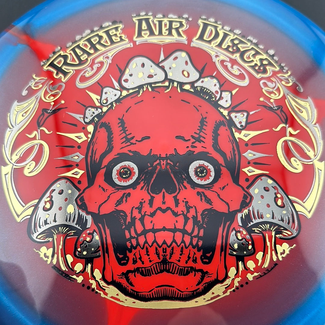 Rare Air Discs Halo S-Blend Conqueror disc golf disc featuring Crushin' Amanitas artwork by Manny Trujillo, with vibrant colors and detailed design.