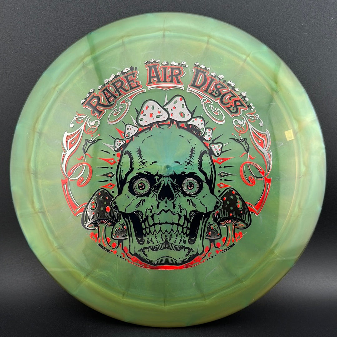 Ethos Construct Crushin' Amanitas disc golf stamp by Manny Trujillo on a Rare Air Discs disc, featuring colorful mushroom artwork.