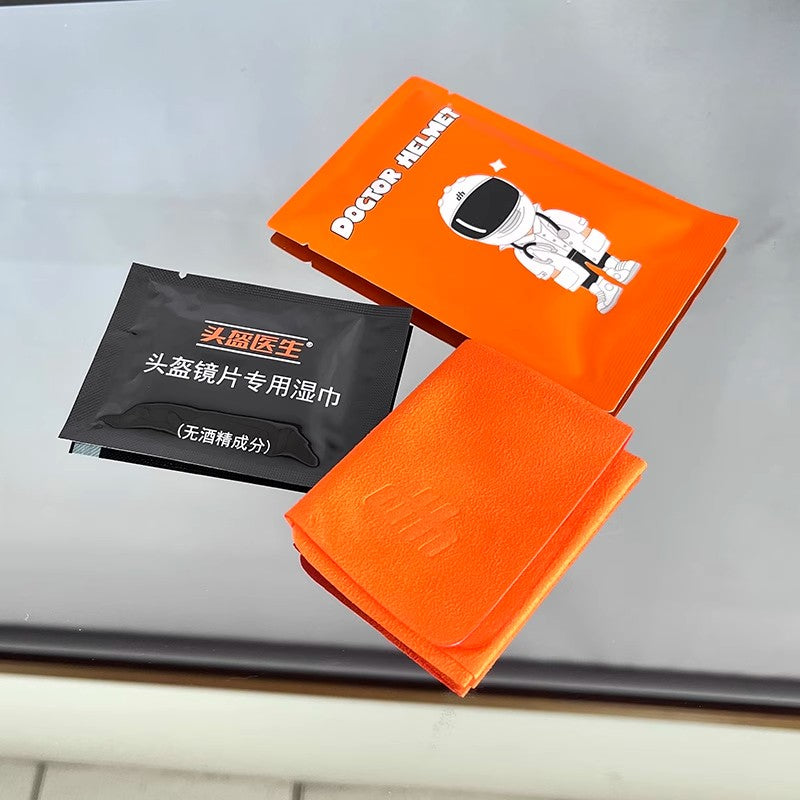 Bean's Moto Booth Doctor Helmet™ disposable lens cleaner kit with a small brush and cleaning cloth for visor maintenance.