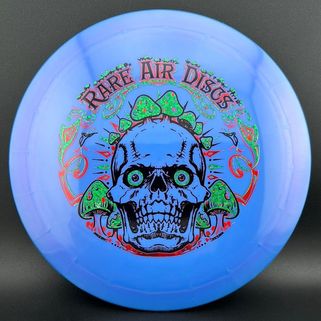 Disc golf stamp by Manny Trujillo featuring Ethereal Construct Crushin' Amanitas design on Rare Air Discs.