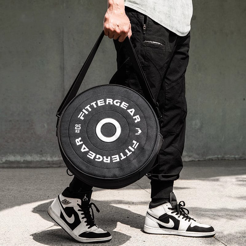 Barbell-shaped gym bag from Bean's Moto Booth, motorcycle-style bag with durable straps and spacious interior for fitness gear.