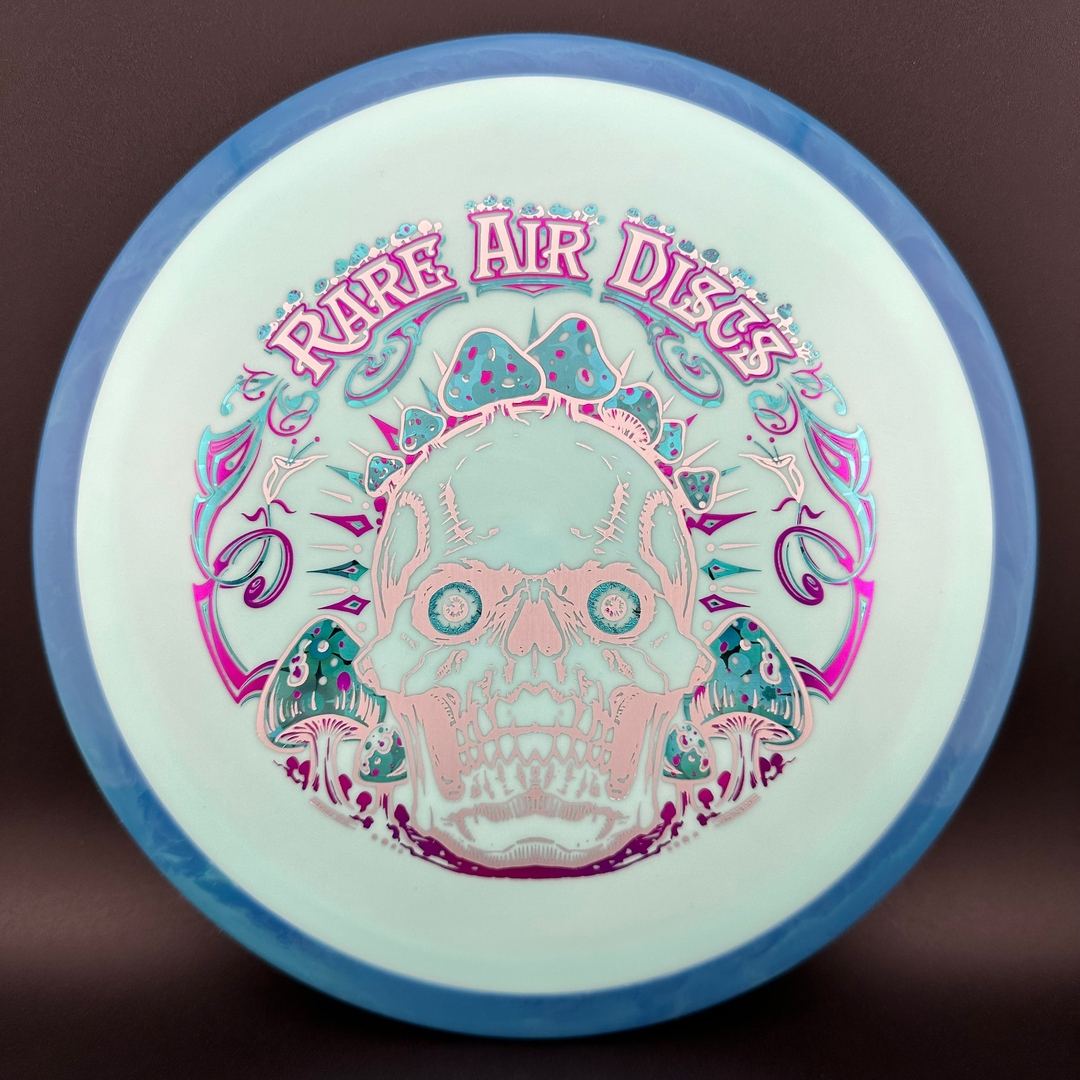 Disc golf disc Fission Defy Crushin' Amanitas VIP 2.0 by Manny Trujillo from Rare Air Discs, featuring vibrant design and bright colors.