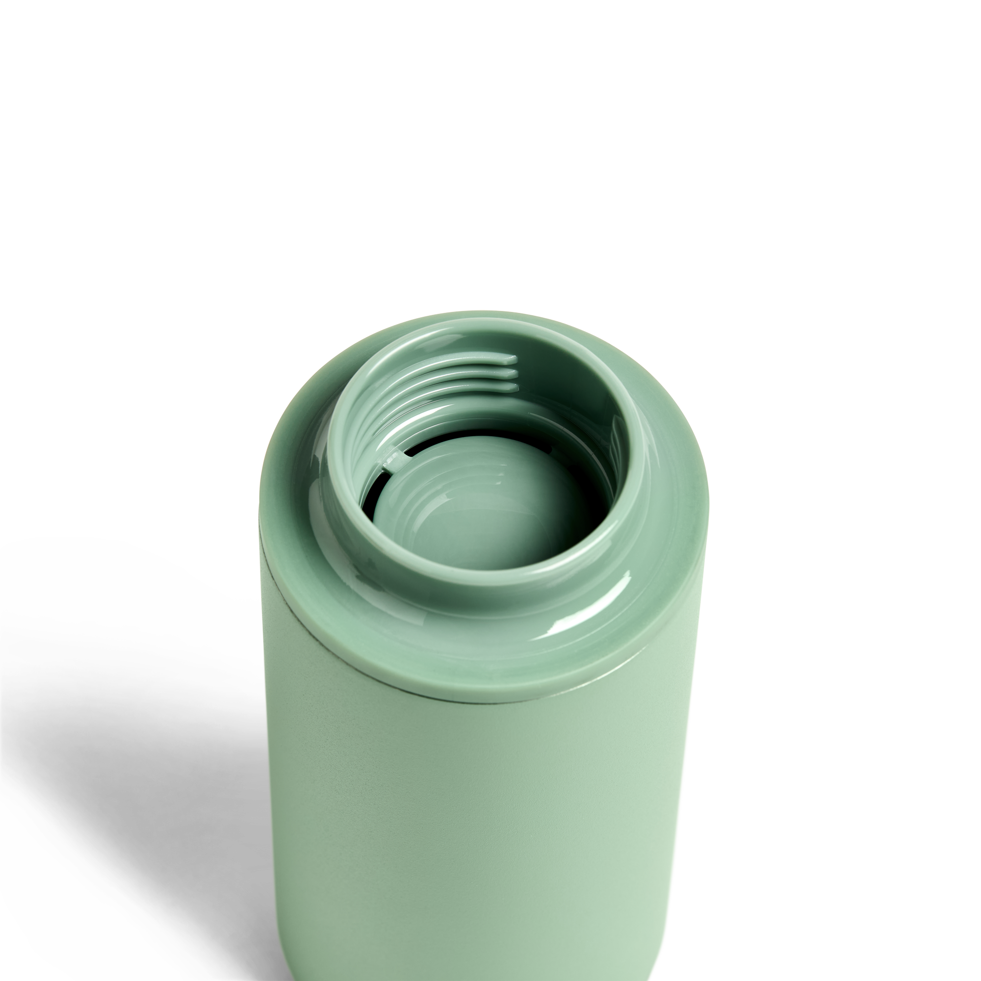 Created Co. 12oz Nomad Grip Tumbler in sage green with textured grip and stainless steel body, ideal for hot or cold beverages.