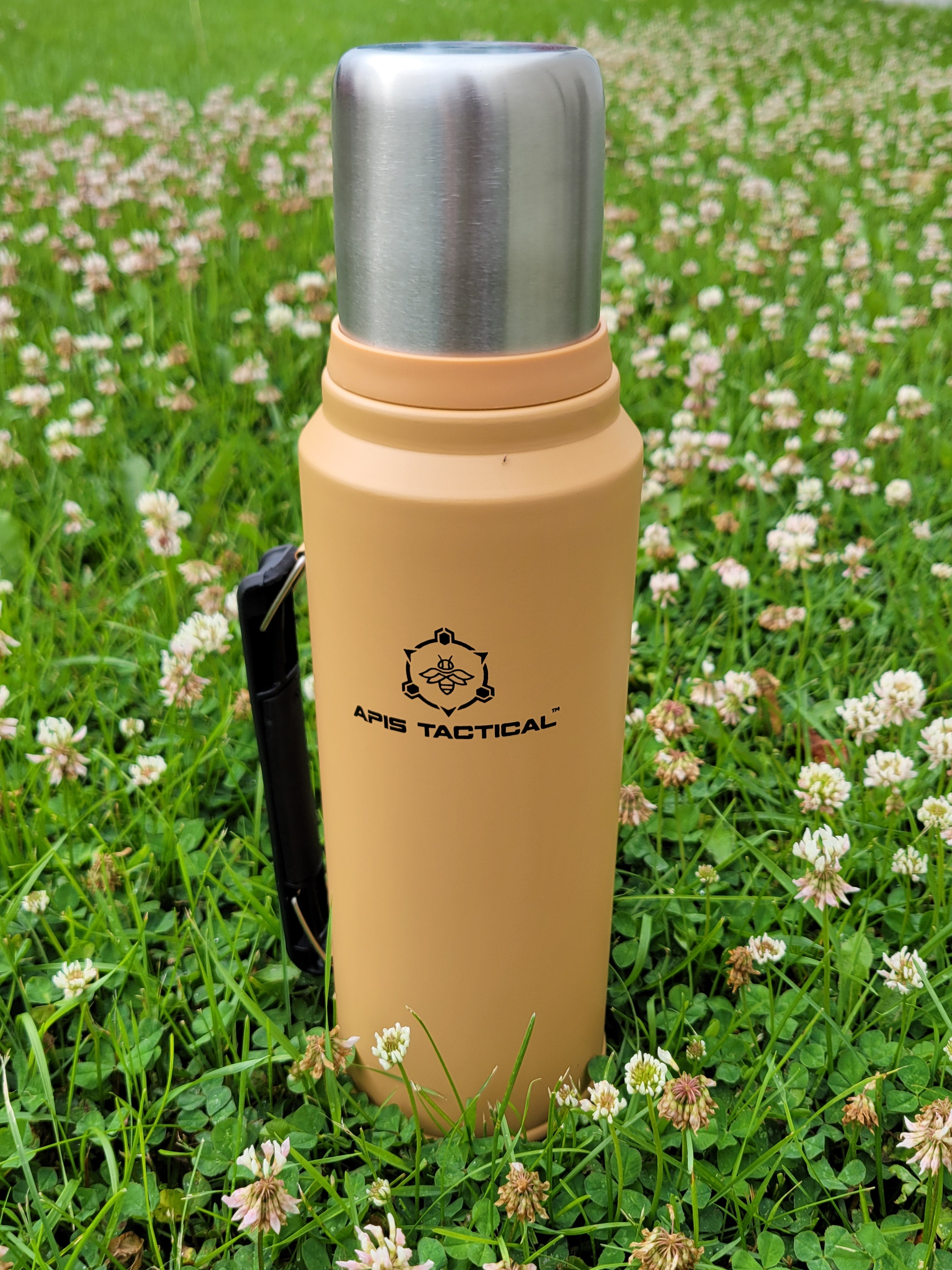 Apis Tactical 1-quart insulated field thermos showing stainless steel body and black screw-on lid for hot and cold beverages.