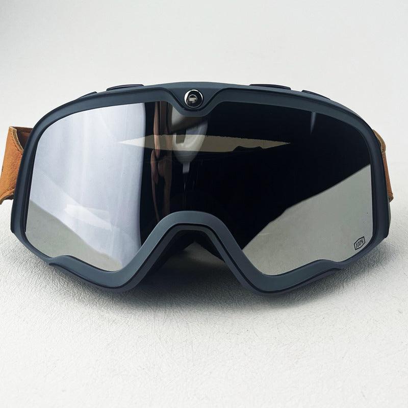 Bean's Moto Booth 100% BARSTOW™ motorcycle goggles with adjustable strap and tinted lenses, designed for motorcycle helmet use.