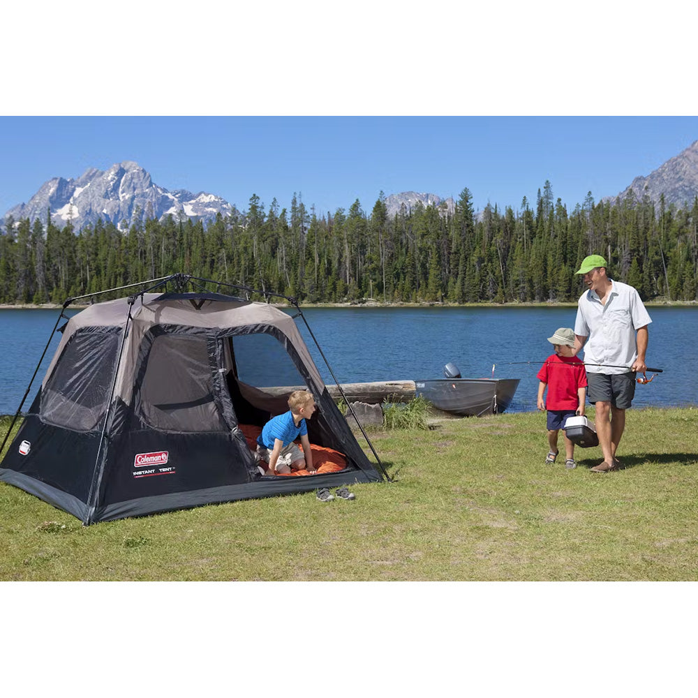Black Coleman 4-person cabin camping tent by TRAPSKI with instant setup, shown set up outdoors with windows and door visible.