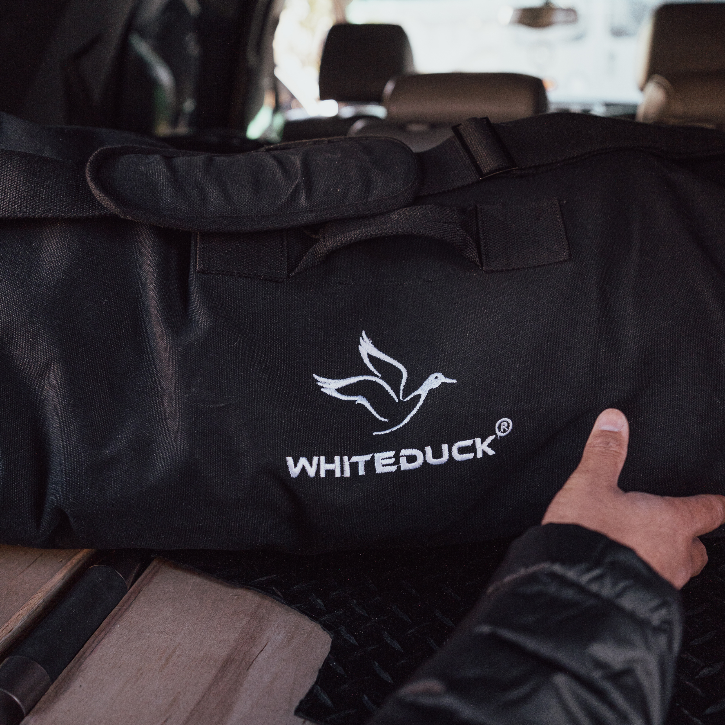 Hoplite Canvas Duffel Bag by White Duck Outdoors showing durable beige canvas material with leather accents and adjustable shoulder strap