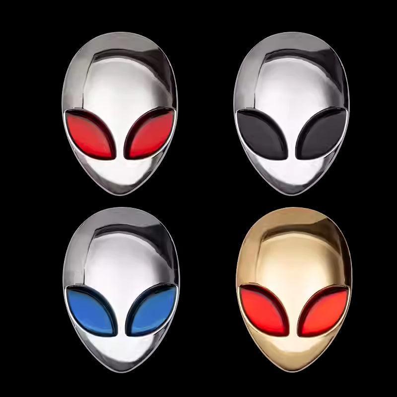 Alien metal emblem by Bean's Moto Booth, featuring a detailed extraterrestrial design on a polished metal surface.