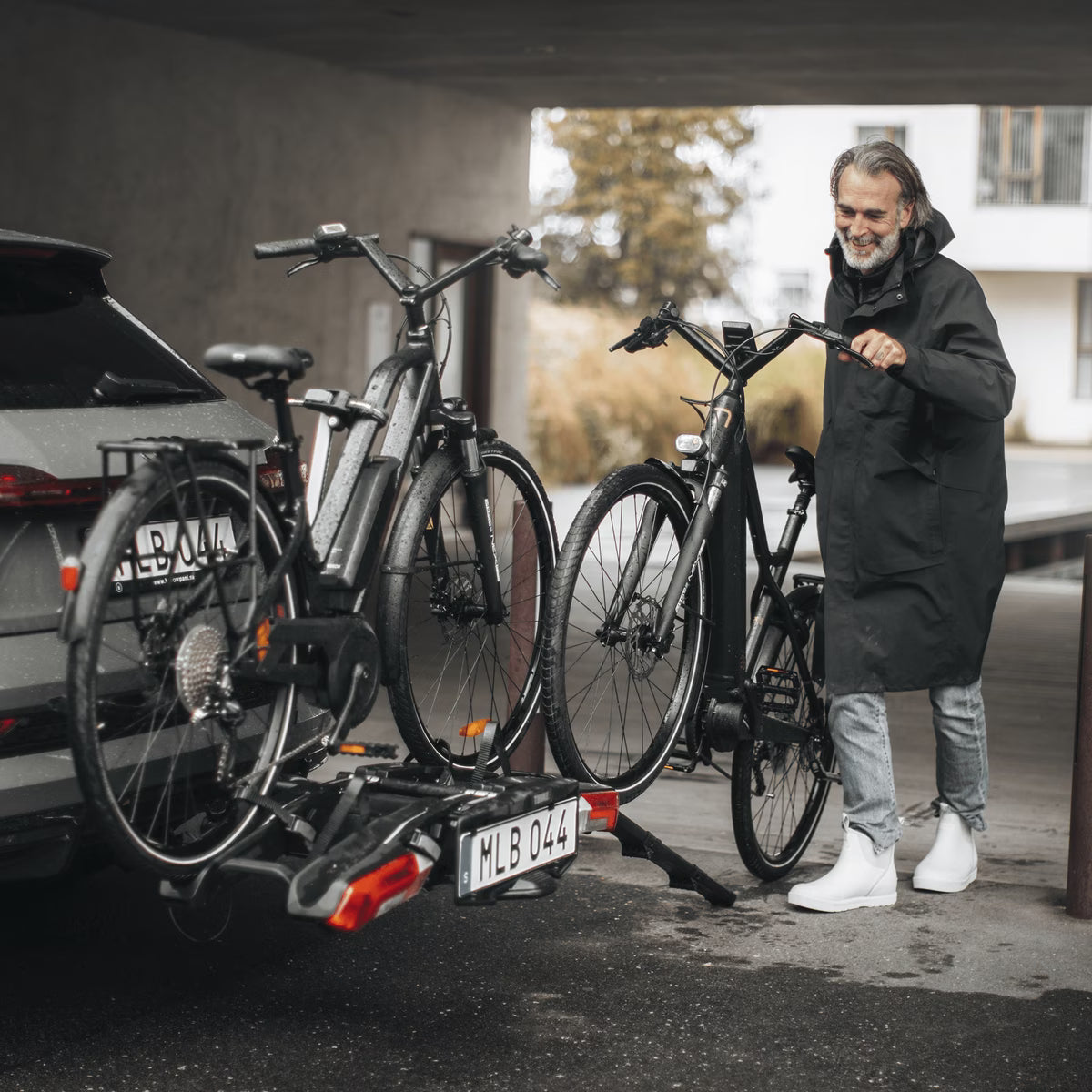 Thule Epos bike rack mounted on vehicle with bikes loaded, backcountry sportsman branding visible, outdoor setting.