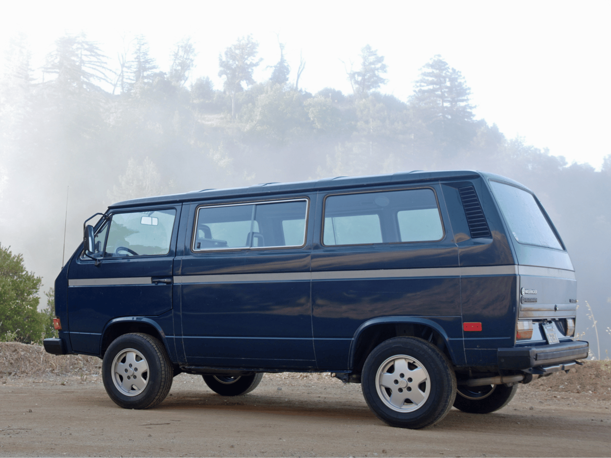 GoWesty OEM Replica alloy wheels for Bus/Vanagon, showing four silver wheels with a clean, modern design for vehicle enhancement.