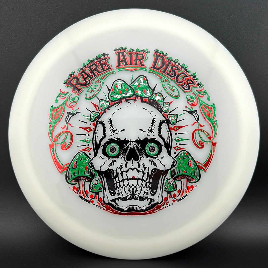 Forged Radiant Era Crushin' Amanitas disc golf stamp by Manny Trujillo on a Rare Air Discs disc, featuring vibrant artwork and detailed design.