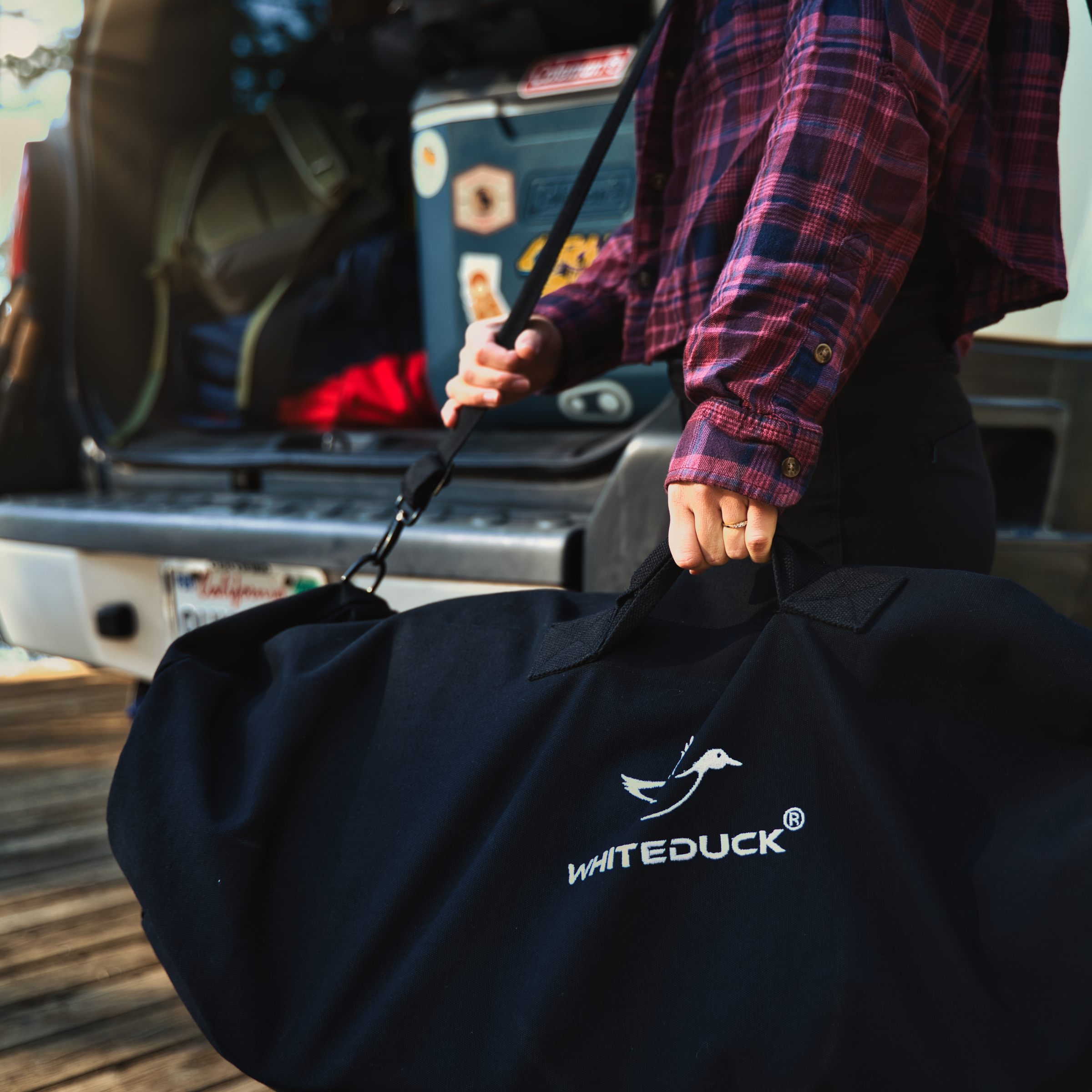 White Duck Outdoors Hoplite Canvas Duffel Bag with sturdy handles and spacious interior, ideal for travel and outdoor adventures.