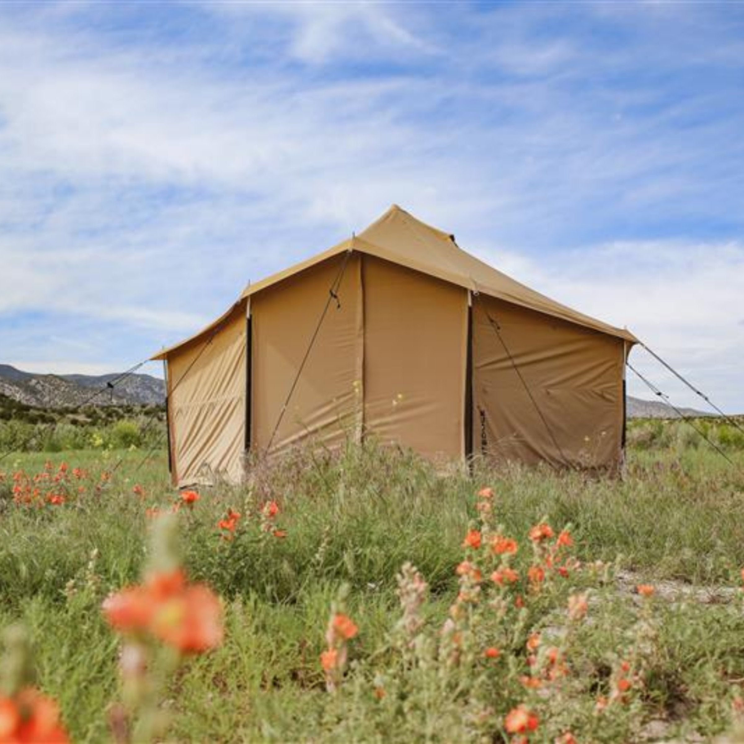 White Duck Outdoors Altimus Bell Tent set up outdoors, showing its spacious circular design and sturdy fabric in a natural setting.
