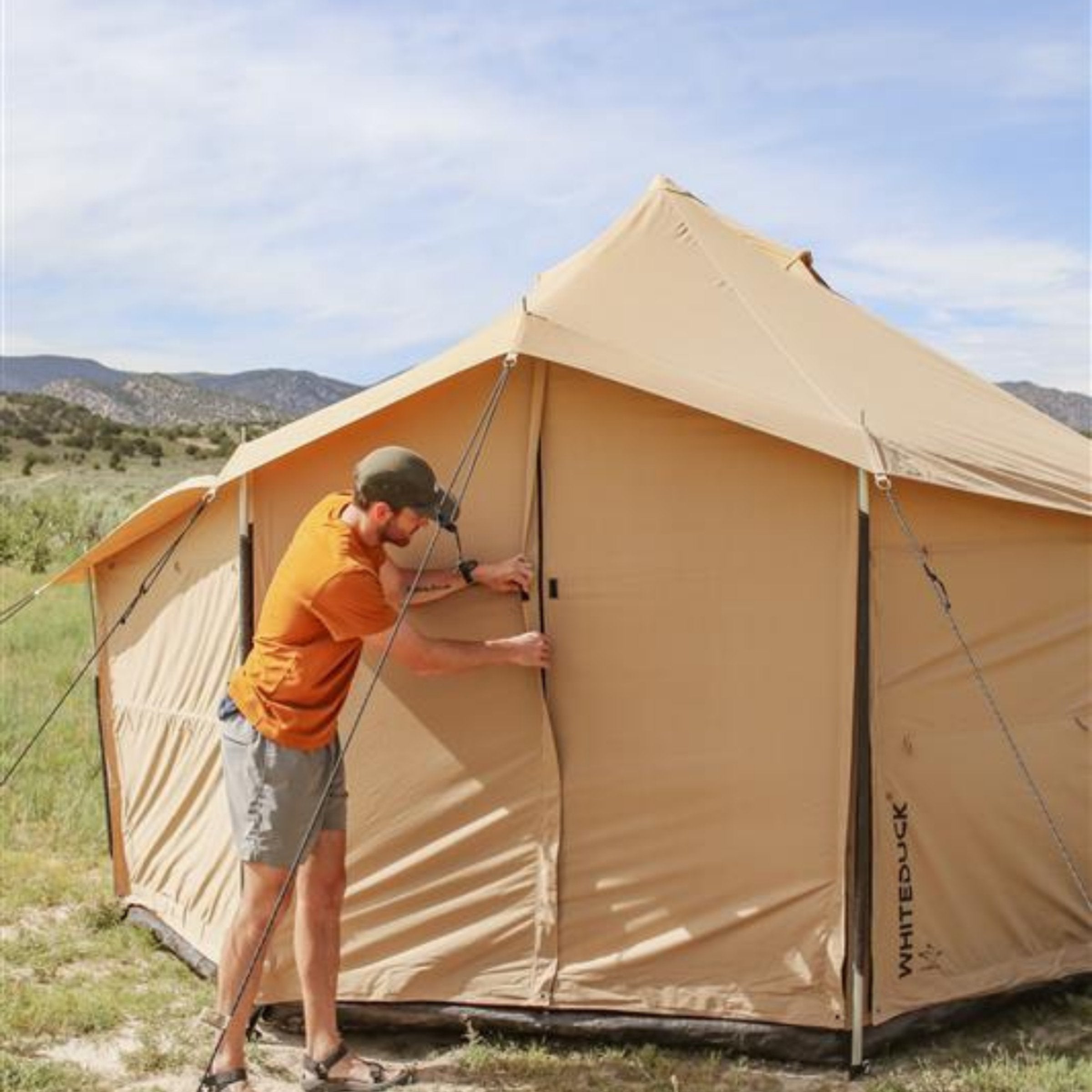 White Duck Outdoors Altimus Bell Tent with flaps closed, showcasing durable canvas fabric and classic bell shape.