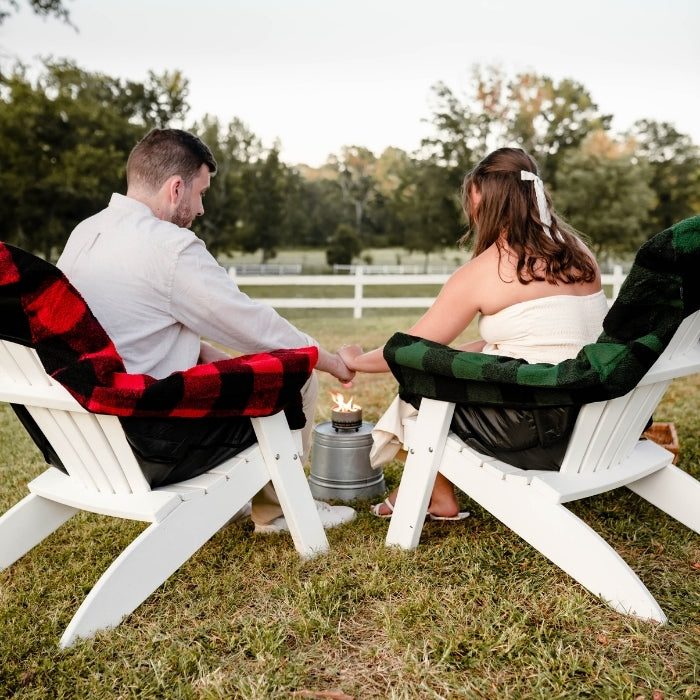 Green plaid City Bonfires Chair Blanket draped over a chair, showcasing cozy, soft fabric and stylish design for outdoor comfort.