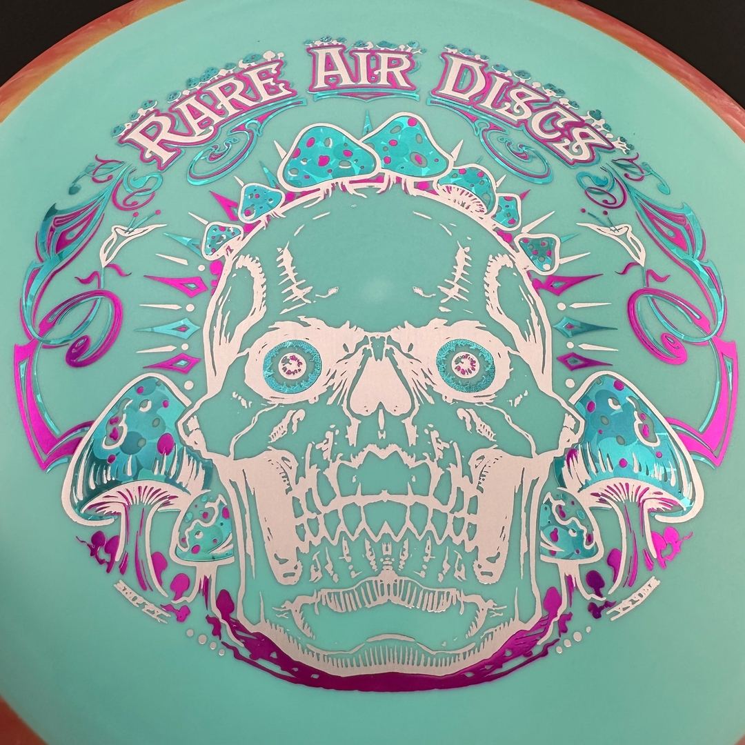 Fission Defy Crushin' Amanitas VIP 2.0 disc golf disc by Rare Air Discs, featuring colorful design and aerodynamic shape.