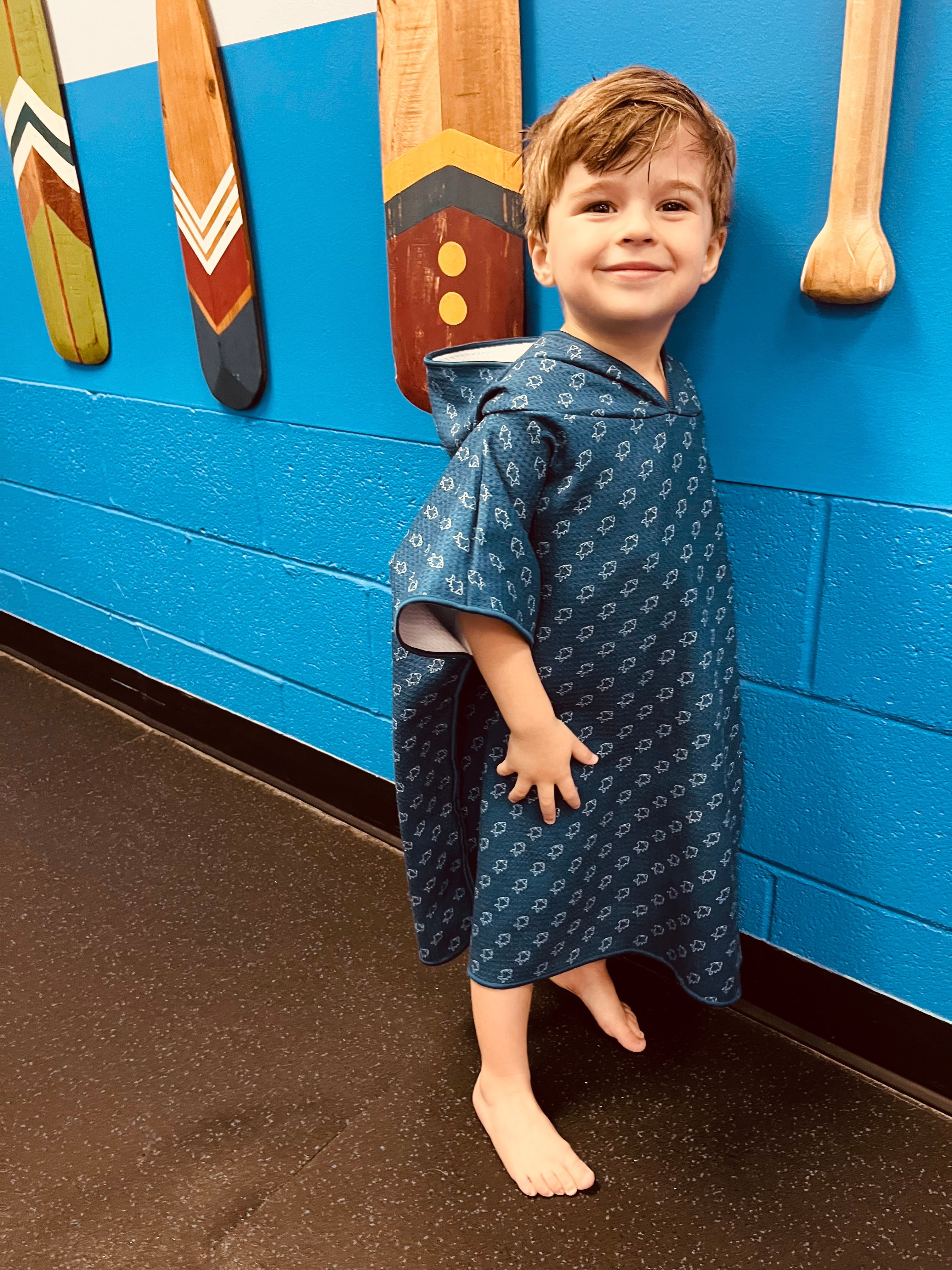 Blue microfiber fish waffle wearable towel by Keep the Littles Wild, showing a cozy, fun towel with fish pattern and waffle texture.
