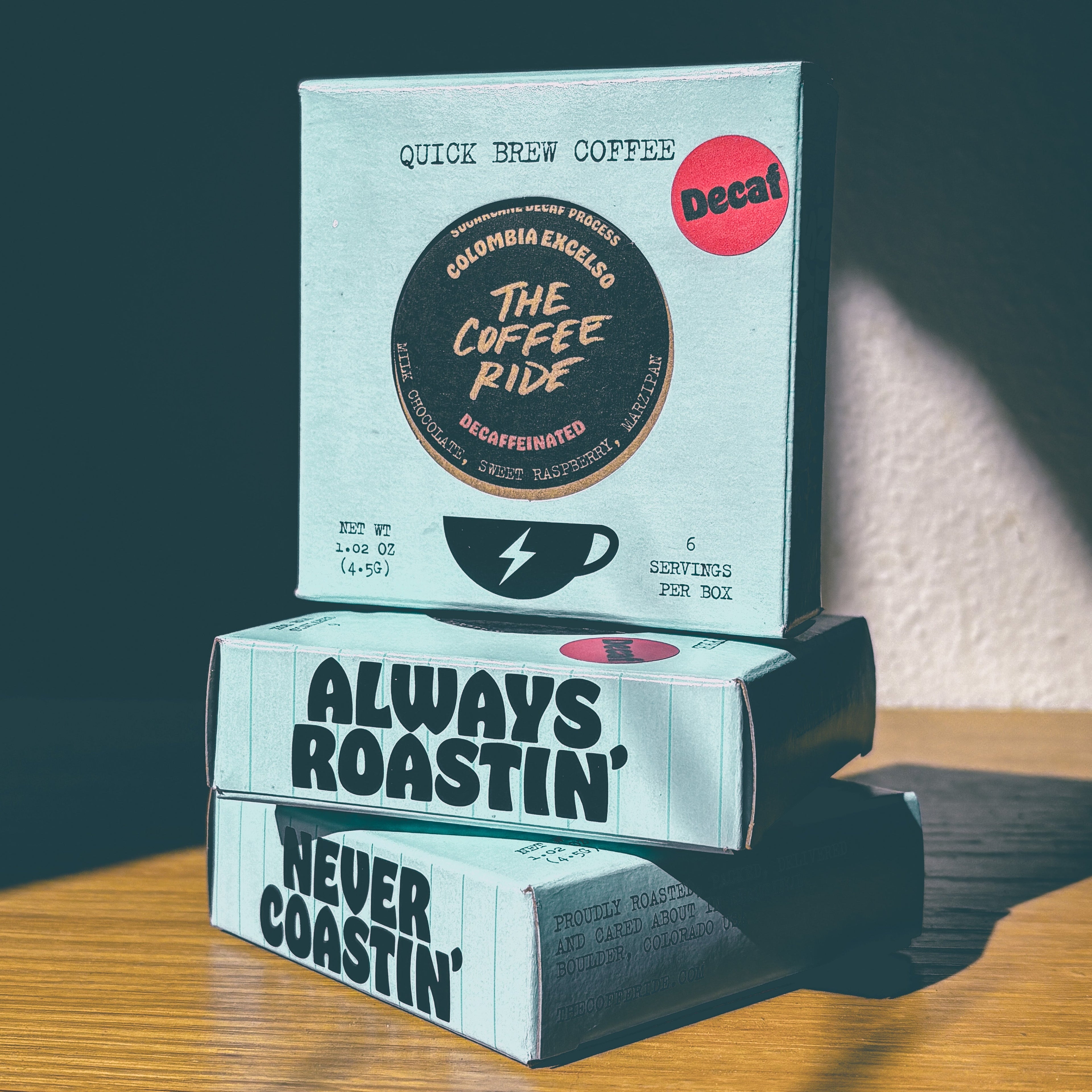 Decaf Colombia coffee bag from The Coffee Ride Coffee Roasting Co., featuring a rich, aromatic roasted coffee beans and packaging.