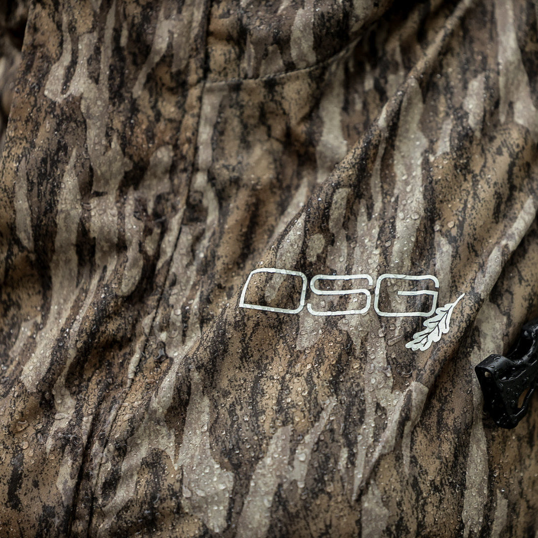 DSG OUTERWEAR Nova rain jacket in waterproof fabric with adjustable hood, shown on a hanger against a plain background.