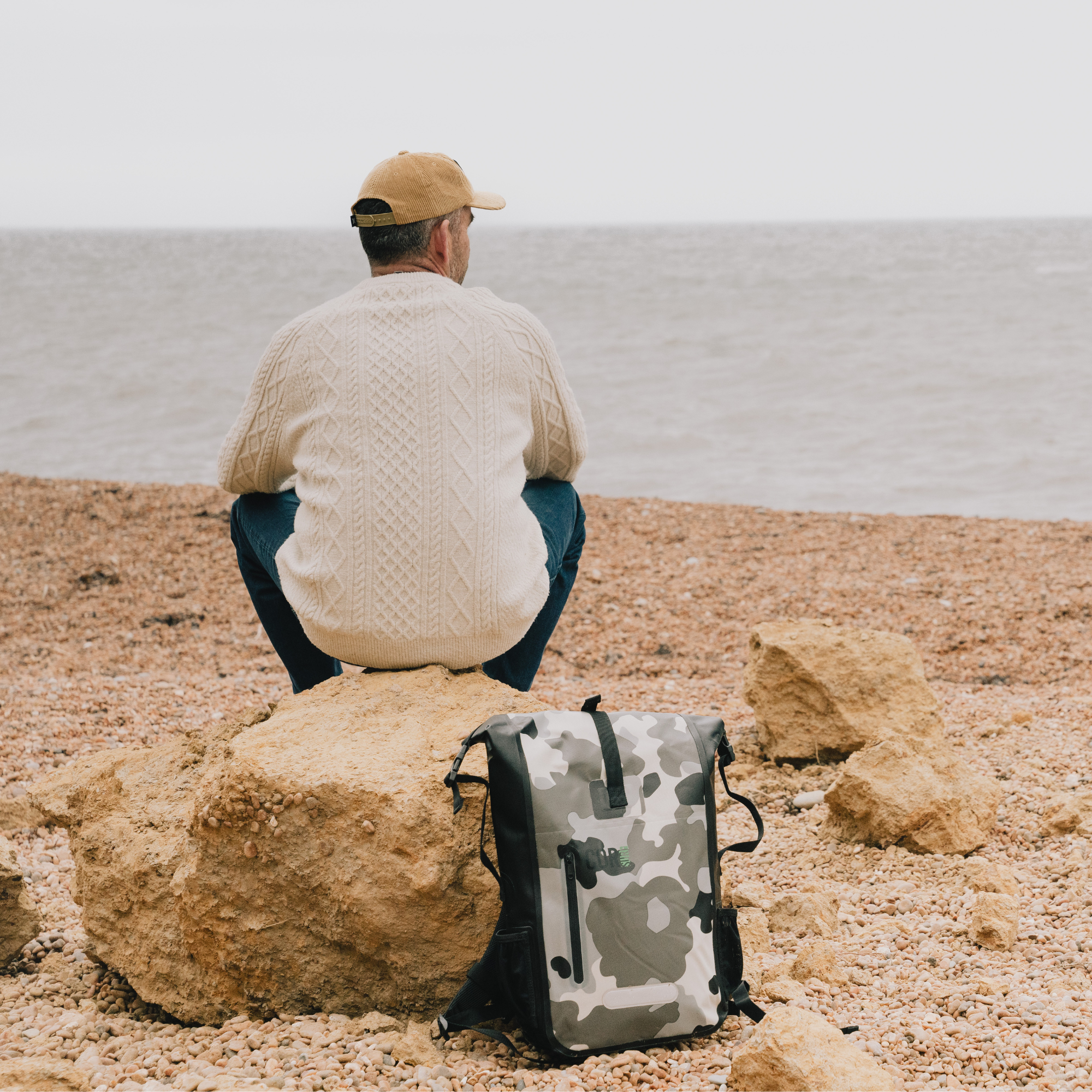 COR Surf 25L waterproof dry backpack showing a sturdy black backpack with adjustable straps and a roll-top closure.
