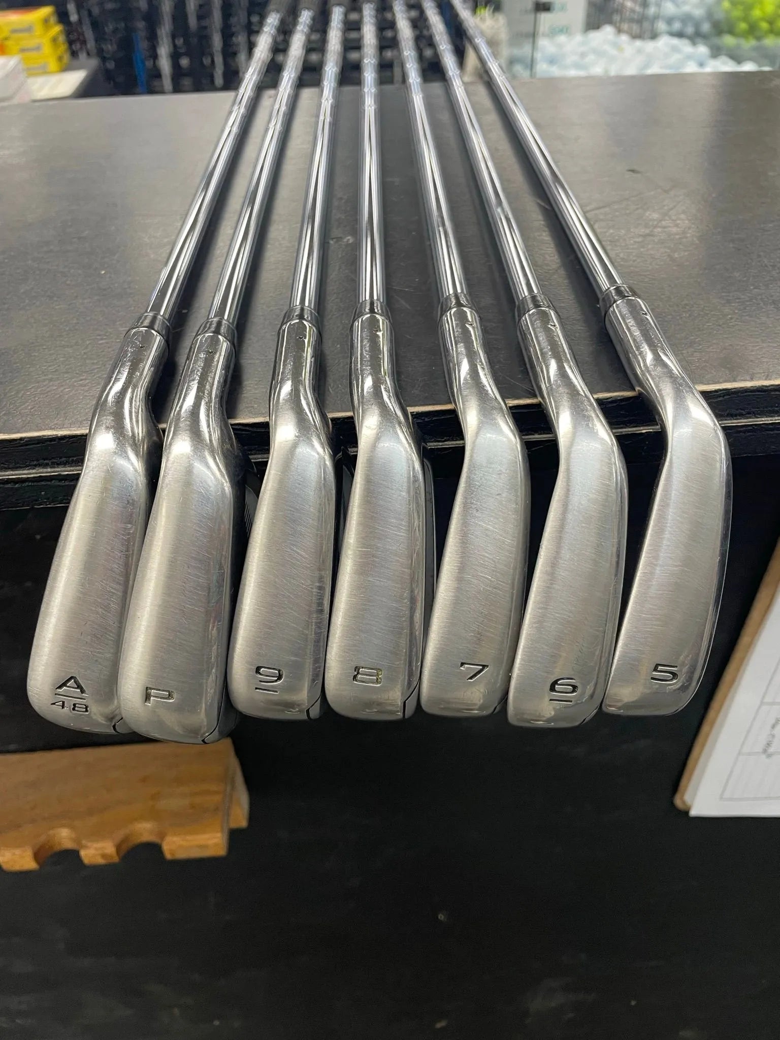 Used Callaway Paradym Ai Smoke Max Fast iron set with graphite shafts, showing the clubheads and grips in a close-up image.