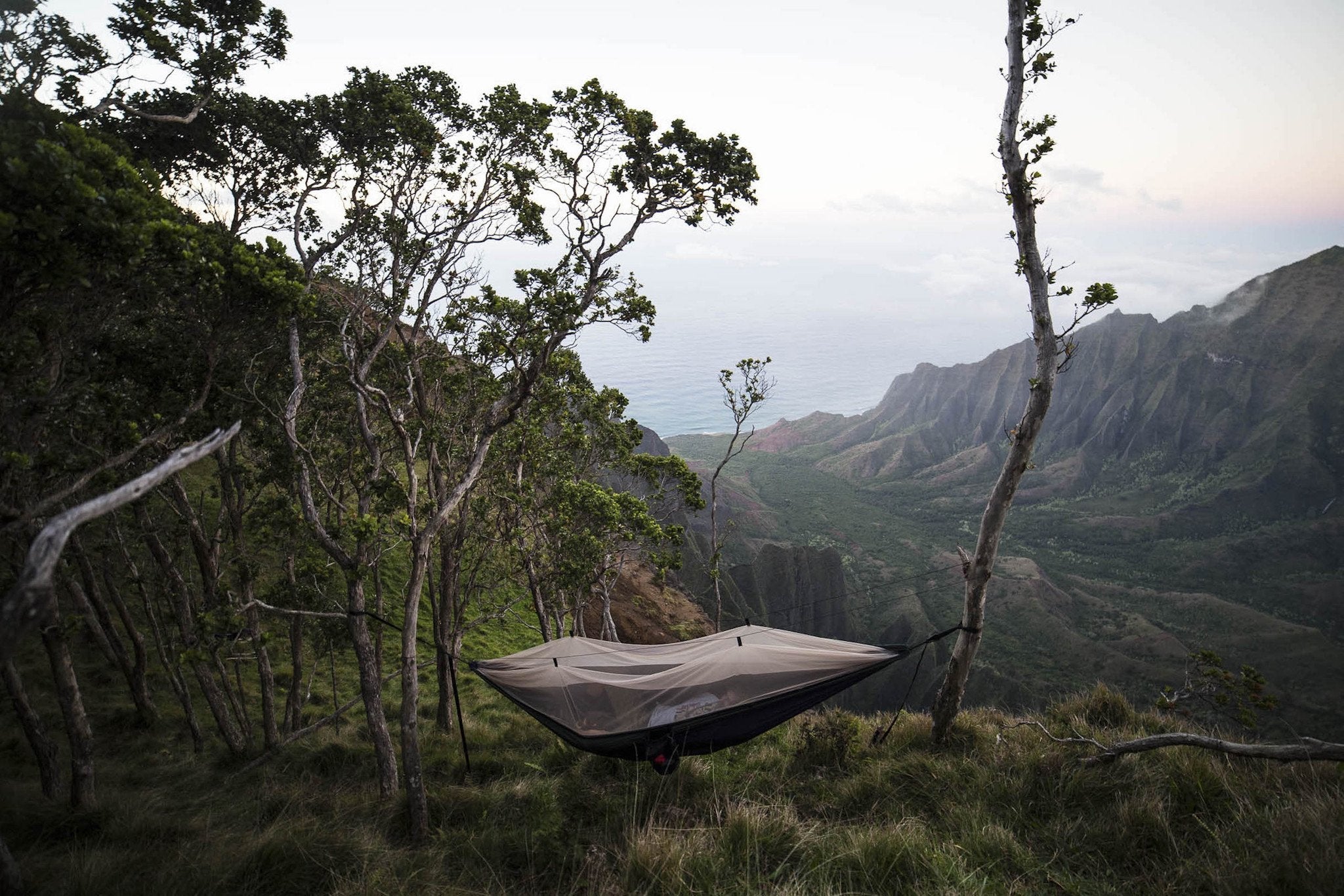 GrandTrunk Skeeter Beeter Pro mosquito net hammock shelter shown outdoors with mesh sides and hanging straps for camping use.