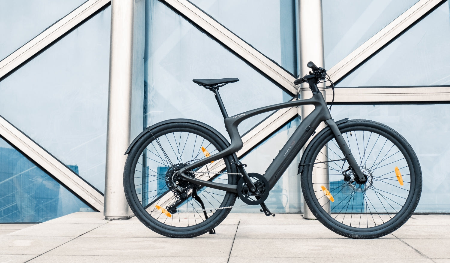 Rex E-Bikes Urtopia Carbon 1 Pro e-bike with sleek black frame, electric motor, and modern design for urban cycling.