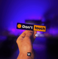 Bean's Moto Booth Don't Touch-Sticker shown on a surface, featuring bold text to warn others to avoid contact.