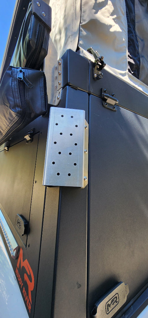 Ambidextrous mount for 5lb and 11lb propane tanks, camping and hiking bracket by Muddy River Outdoors, shown on a camping setup.
