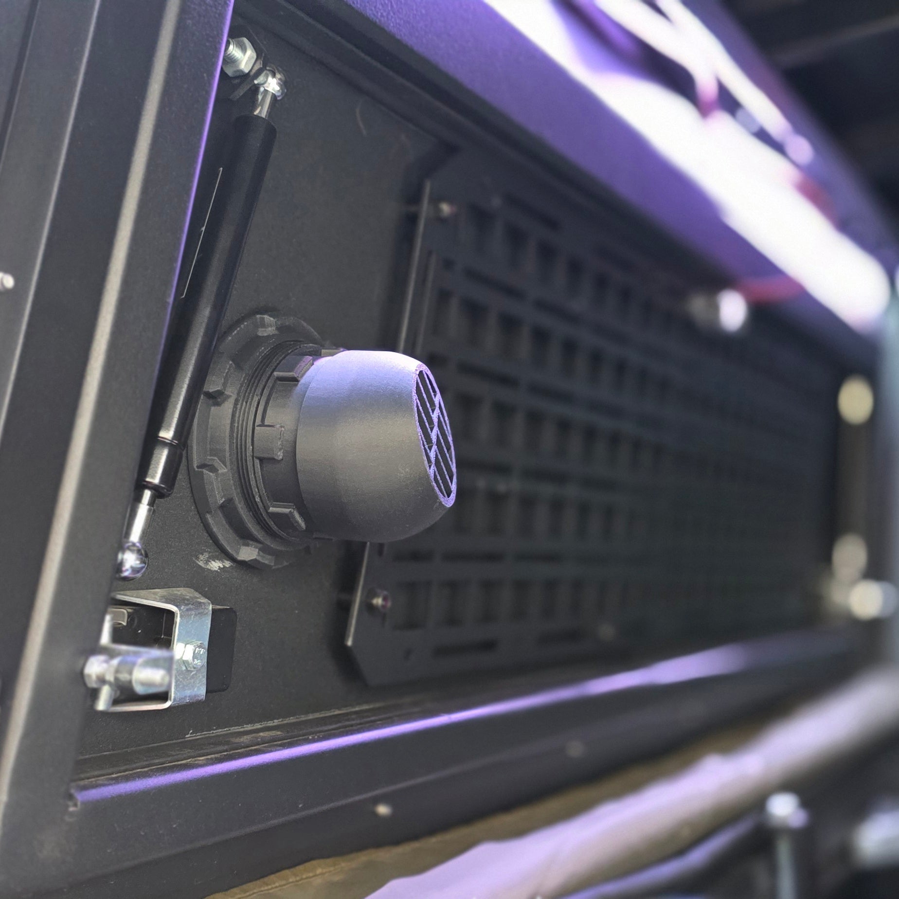 Muddy River Outdoors diesel heater port for campers and toppers, showcasing the durable pass-through design and rugged materials.