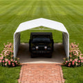 Heavy-duty outdoor galvanized steel carport measuring 20x30ft, set up in a front yard, by SAKSBY WHOLESALE.