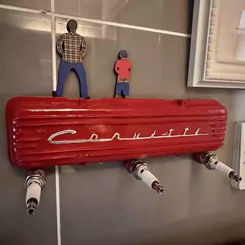 Vintage resin spark plug hook rack by Bean's Moto Booth, featuring a retro automotive design with multiple hooks for hanging items.