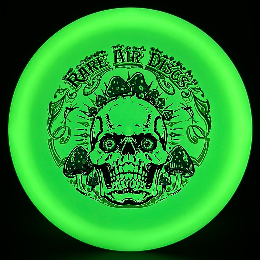 Disc golf stamp featuring Crushin' Amanitas design by Manny Trujillo on a Forged Radiant Era disc from Rare Air Discs.