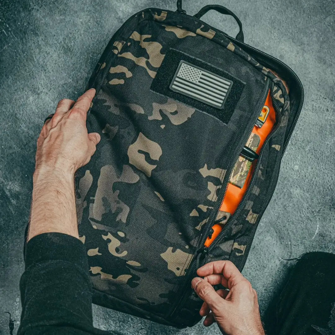 Recycled Firefighter 24 Hour Backpack in dark camouflage with multiple compartments and sturdy 500D material for durable use.