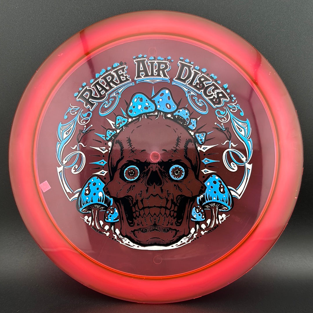 Ethos Construct Crushin' Amanitas disc golf stamp by Manny Trujillo on a Rare Air Discs disc, featuring colorful mushroom artwork.