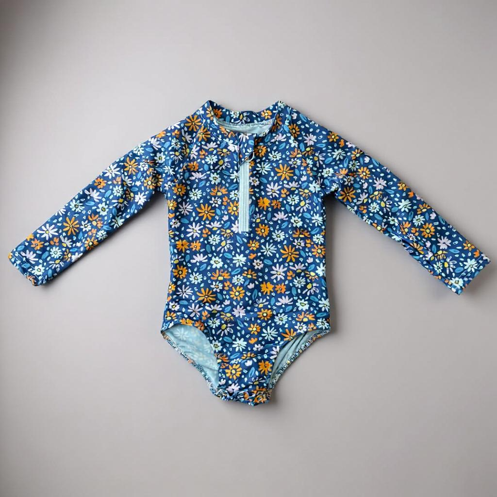Colorful flowers swimsuit by Keep the Littles Wild featuring vibrant floral pattern and adjustable straps for kids.