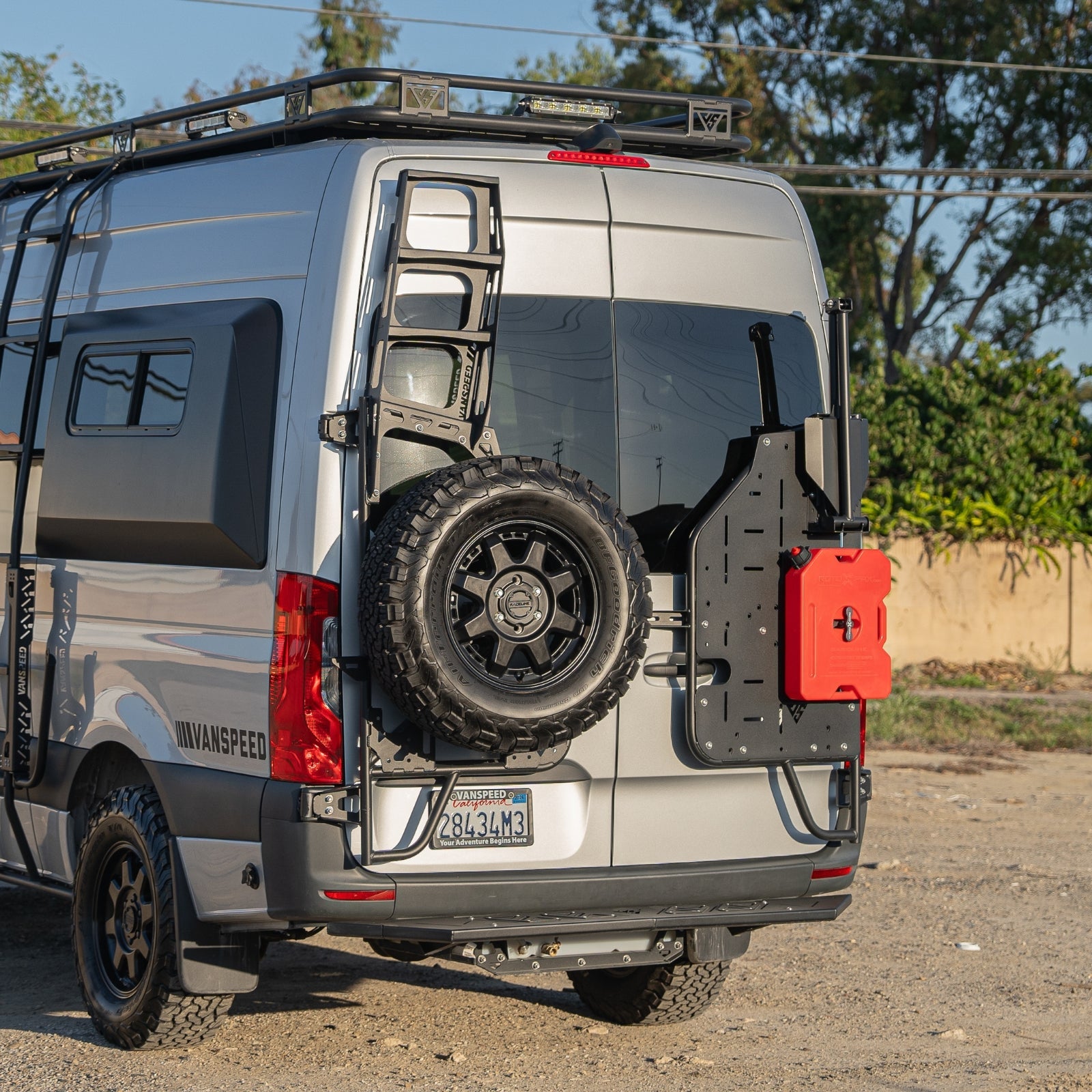 Vanspeed Sprinter rear tire carrier mounted on van exterior, durable metal construction for secure tire storage by The Van Mart