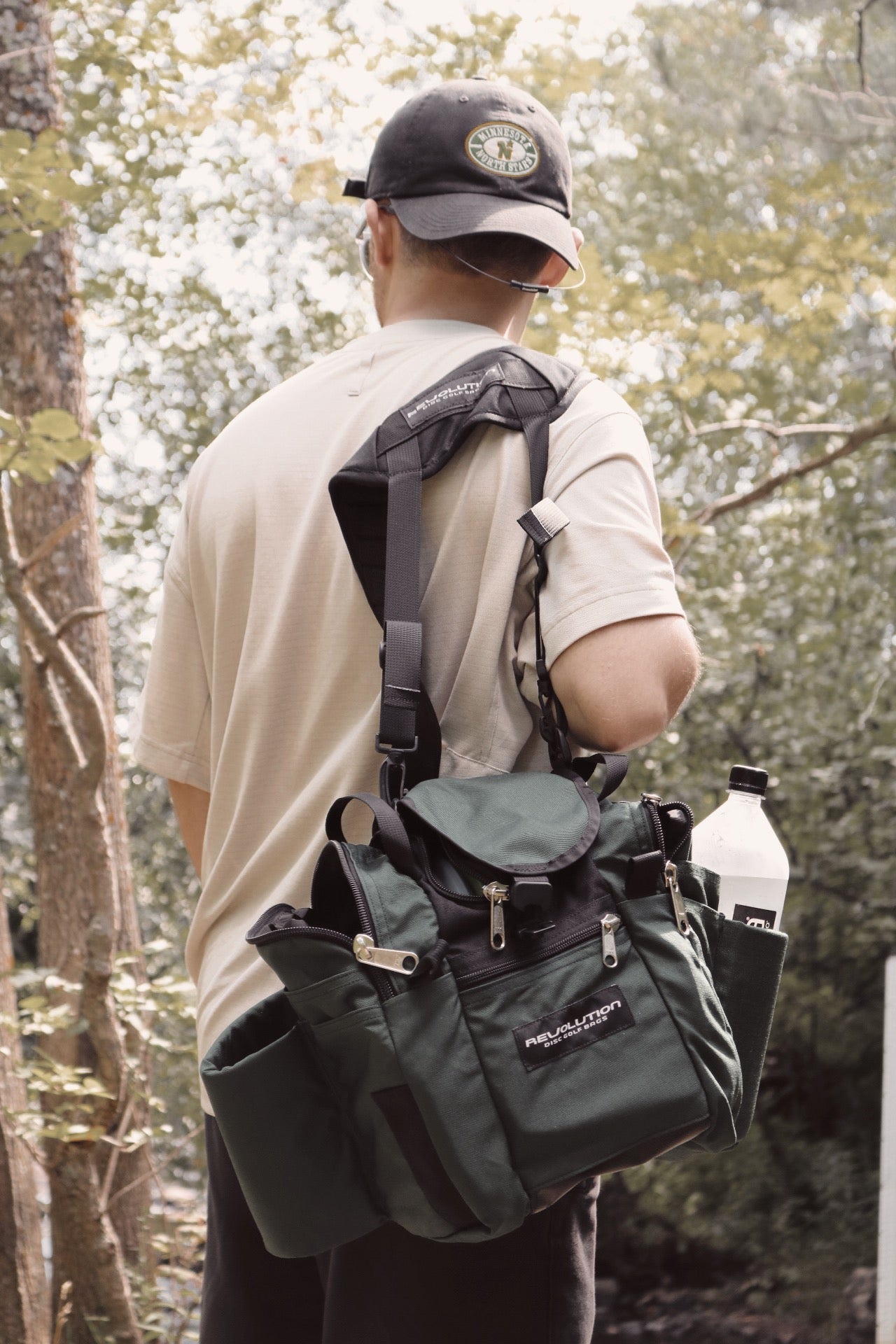 Gotta Go Gotta Throw Revolution Mini Deluxe V3 disc golf bag in rust color, compact with multiple storage compartments and disc slots.