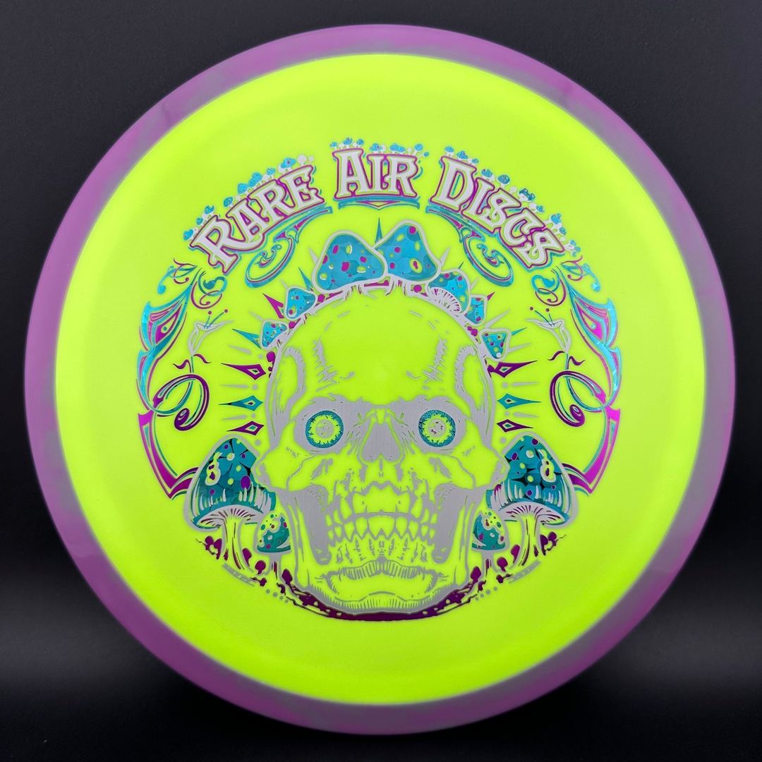 Rare Air Discs Fission Defy Crushin' Amanitas VIP 2.0 disc golf disc with vibrant design on a white background