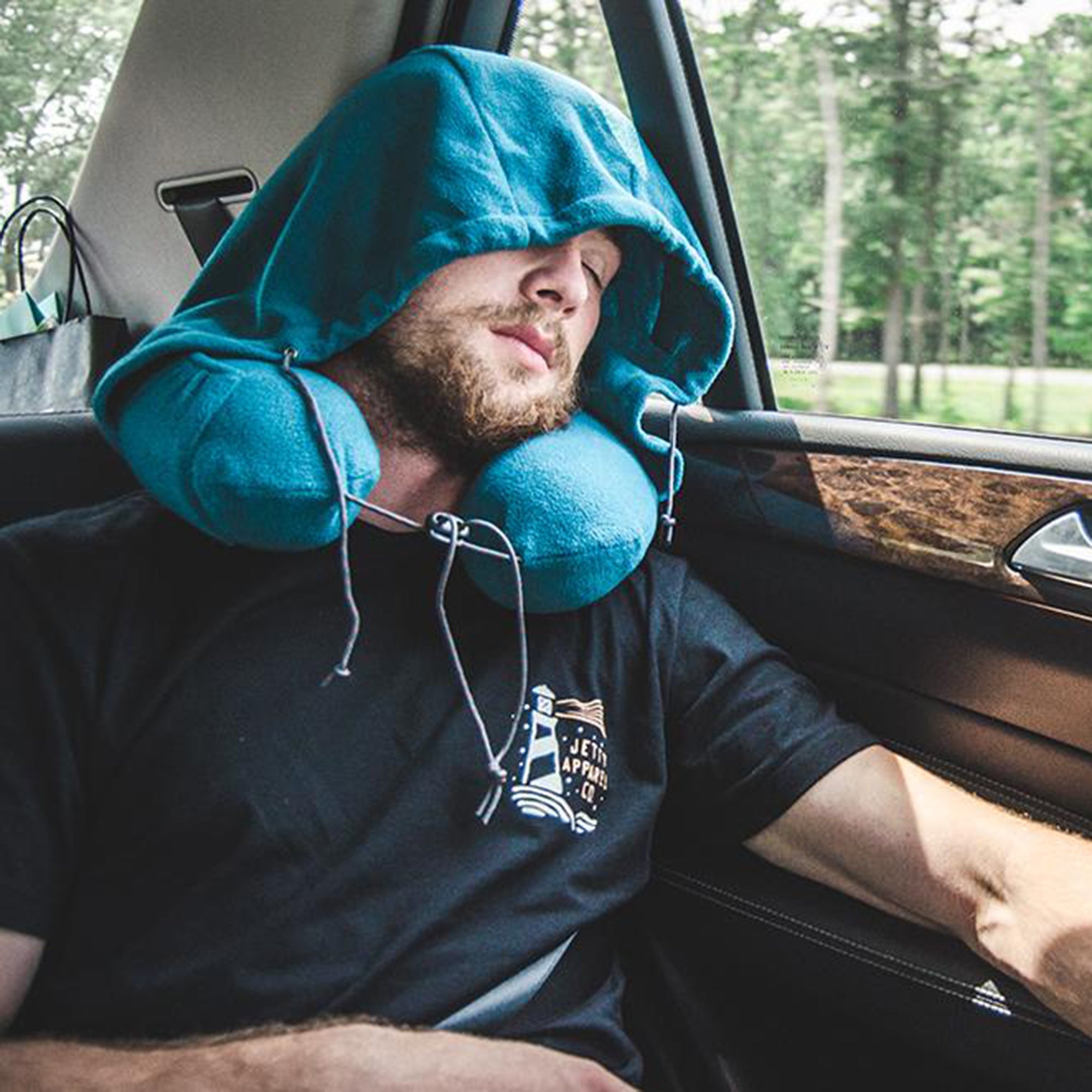 GrandTrunk hooded travel neck pillow in gray, featuring soft fabric and ergonomic design for comfort during travel.