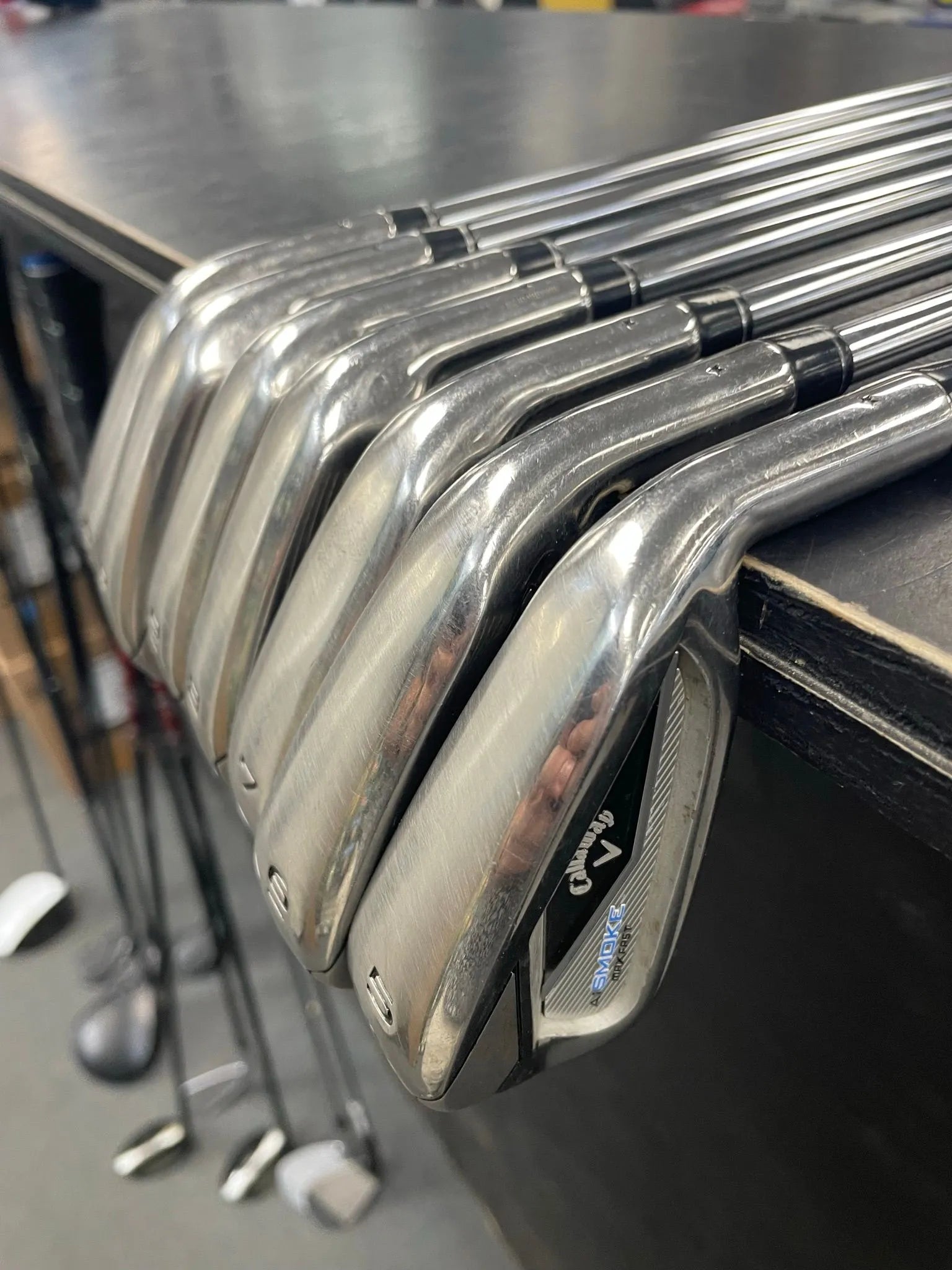 Used Callaway Paradym Ai Smoke Max Fast Iron Set, golf clubs with black and gray finish, showing club heads and grips.