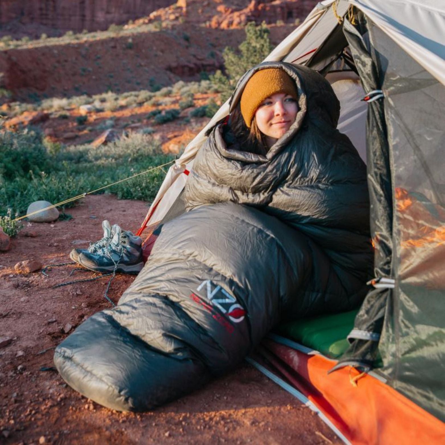Near Zero Outdoor Gear NZ 20 Mummy Sleeping Bag in a cozy, compact design, showcasing its hood and zipper features.