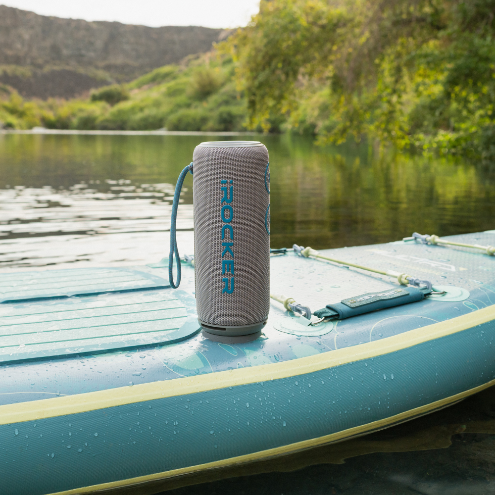 iROCKER US MAG SPEAKER X showing its compact design and control buttons on a sleek black surface.