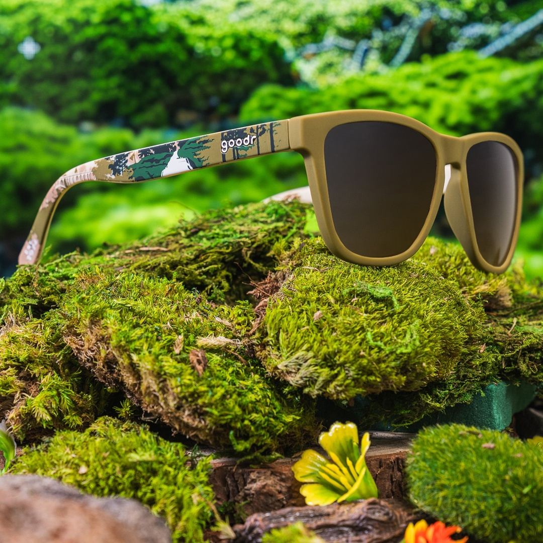 Rare Air Discs Cuyahoga Valley polarized sunglasses with black frames and tinted lenses, outdoor lifestyle shot.